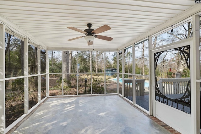 unfurnished sunroom featuring ceiling fan