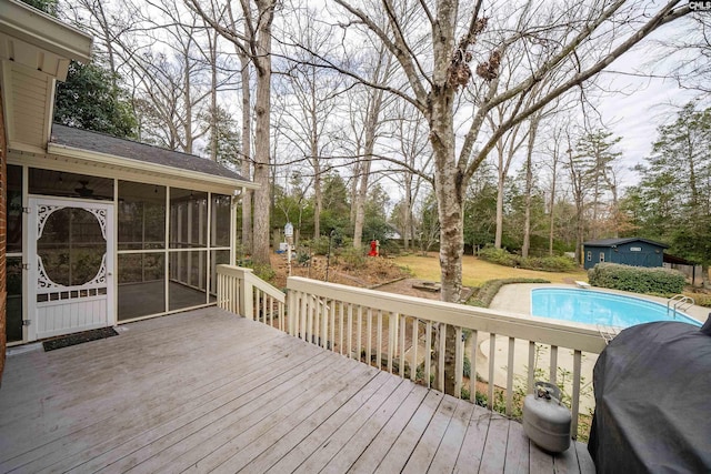 wooden terrace with a sunroom and area for grilling