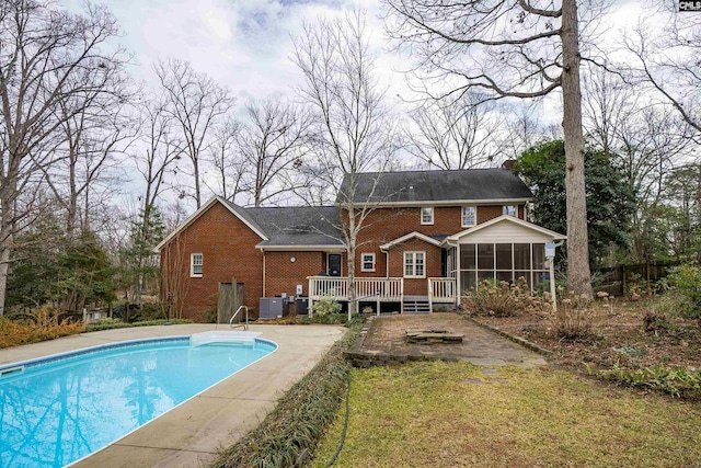 back of house featuring a pool side deck, central AC unit, and a sunroom