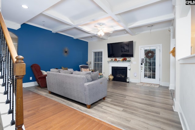 living room with crown molding, ceiling fan, beam ceiling, coffered ceiling, and wood-type flooring