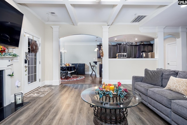 living room with ornate columns, coffered ceiling, and dark hardwood / wood-style floors