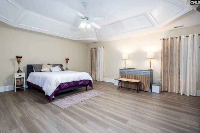 bedroom with ceiling fan, coffered ceiling, and hardwood / wood-style floors