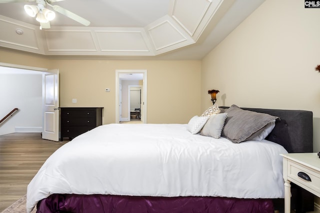 bedroom featuring coffered ceiling, hardwood / wood-style flooring, and vaulted ceiling