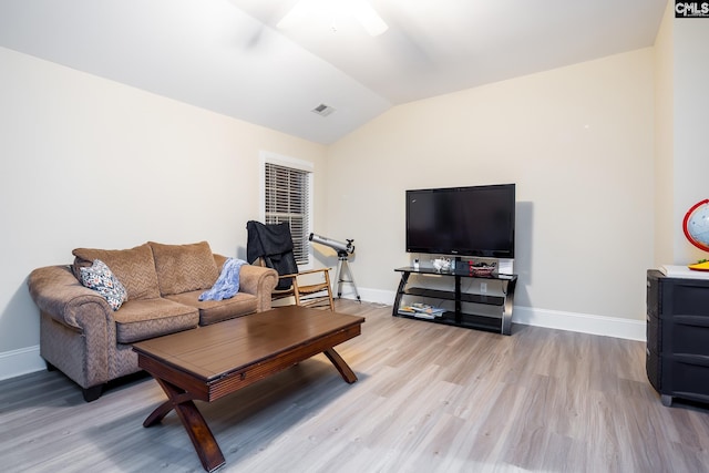 living room featuring vaulted ceiling and light hardwood / wood-style flooring