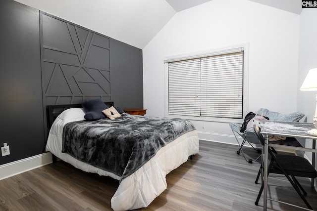 bedroom with vaulted ceiling and wood-type flooring