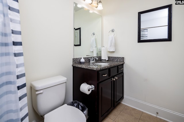 bathroom with vanity, curtained shower, tile patterned floors, and toilet