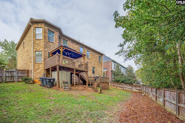 back of house with a wooden deck and a yard