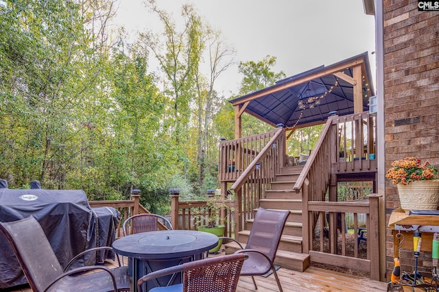 deck with area for grilling and a gazebo