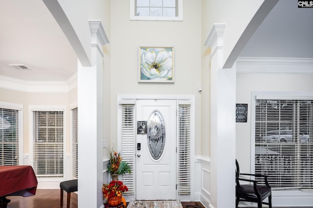 foyer with crown molding and hardwood / wood-style flooring