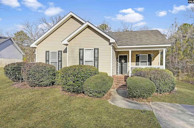 view of front of home featuring a front yard and covered porch