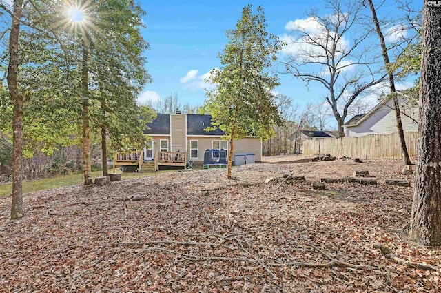 rear view of property with a wooden deck