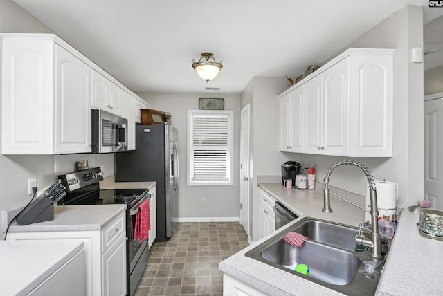 kitchen with stainless steel appliances, sink, and white cabinets