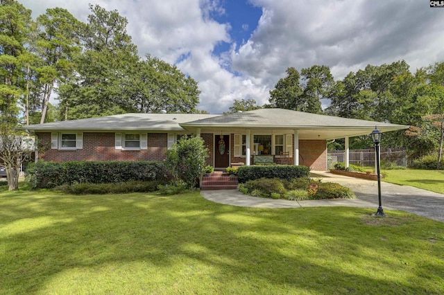 view of front of house with a carport, a porch, and a front yard