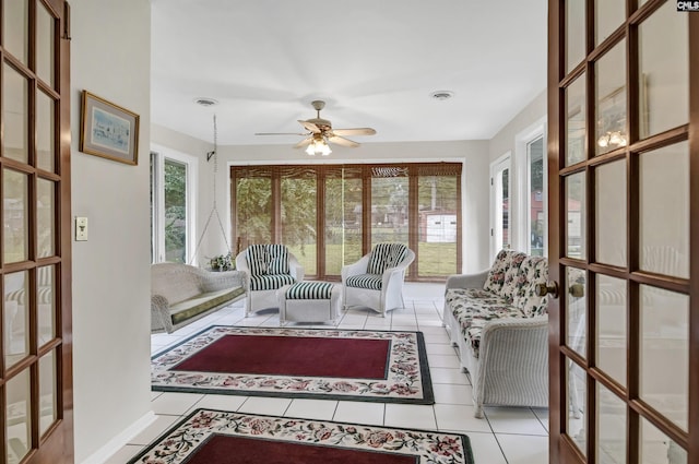 sunroom / solarium featuring ceiling fan