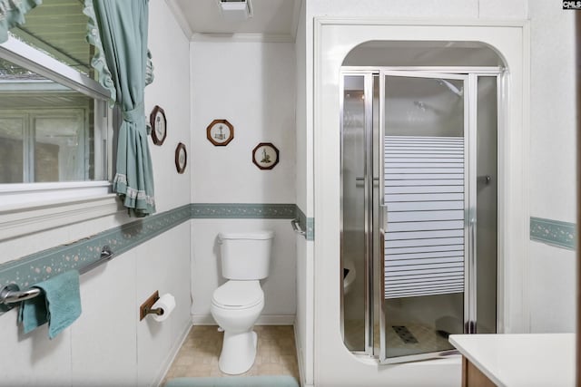 bathroom with crown molding, vanity, toilet, and an enclosed shower