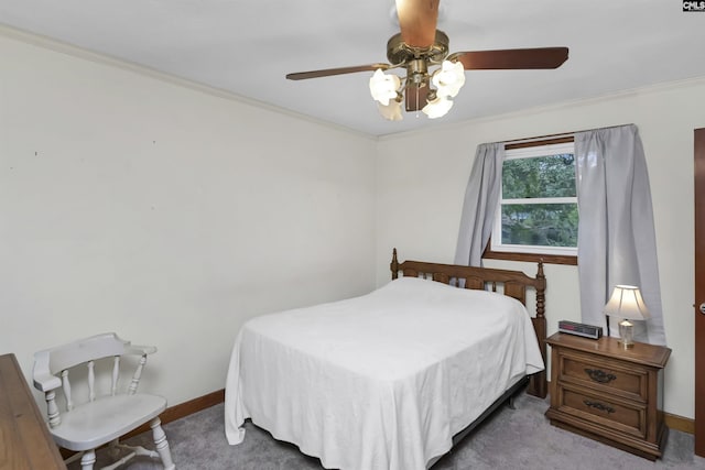 carpeted bedroom featuring crown molding and ceiling fan