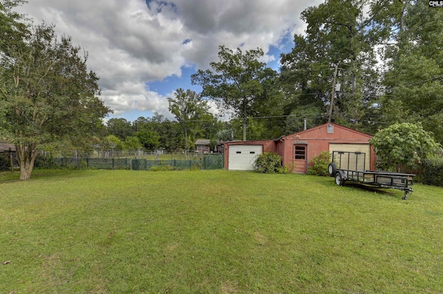 view of yard with a garage and an outdoor structure