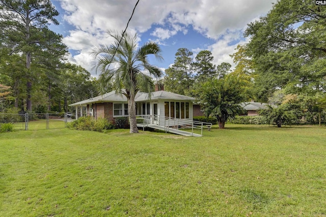 back of house featuring a lawn