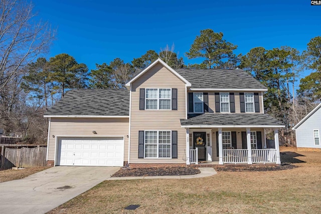 colonial home featuring a garage, a front yard, and covered porch