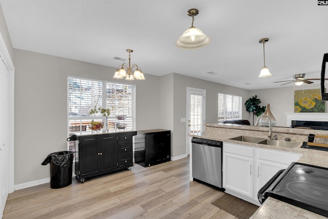 kitchen featuring stainless steel dishwasher, decorative light fixtures, sink, and electric range