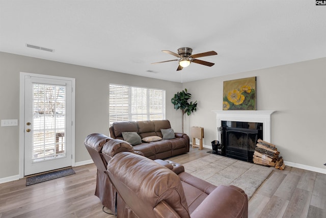 living room featuring light hardwood / wood-style flooring and ceiling fan