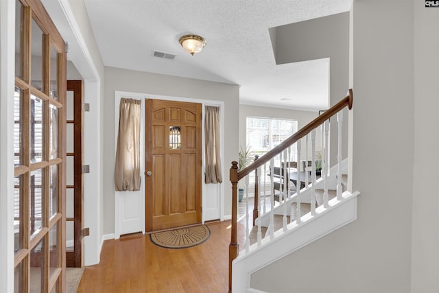 entrance foyer featuring hardwood / wood-style floors and a textured ceiling