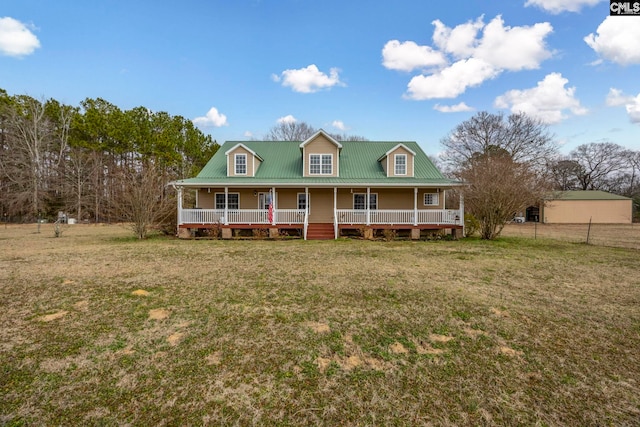 country-style home featuring a front yard and covered porch