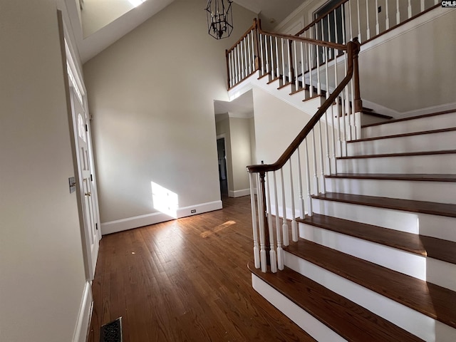 foyer entrance featuring a high ceiling and dark hardwood / wood-style floors