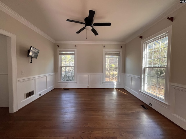 unfurnished room featuring crown molding, dark wood-type flooring, and ceiling fan