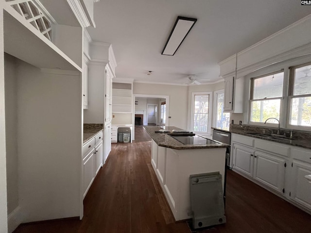 kitchen featuring sink, white cabinetry, a center island, plenty of natural light, and dark hardwood / wood-style floors