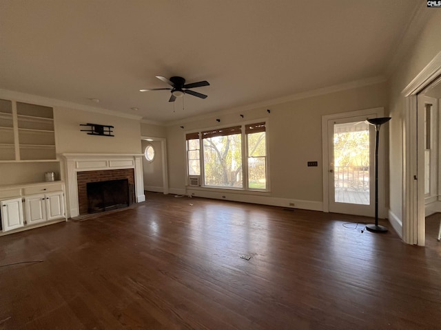 unfurnished living room with crown molding, a healthy amount of sunlight, a fireplace, and dark hardwood / wood-style flooring