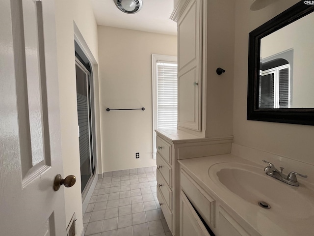 bathroom with vanity, an enclosed shower, and tile patterned flooring