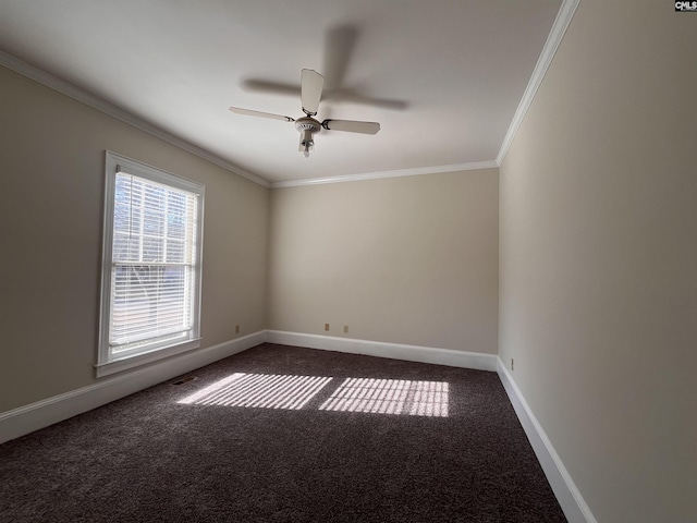 empty room with dark colored carpet, ornamental molding, and ceiling fan