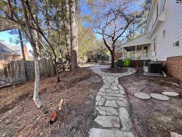 view of yard with cooling unit and a porch