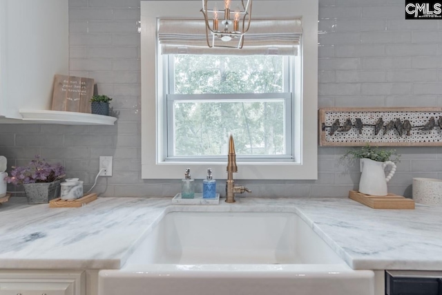 details featuring light stone counters and sink