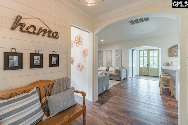 hall featuring crown molding, hardwood / wood-style floors, and french doors