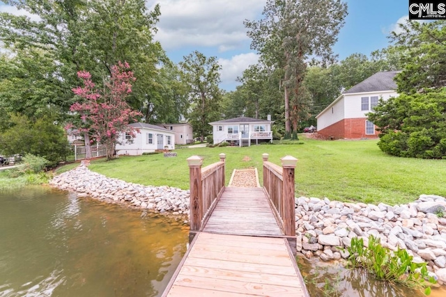 dock area featuring a yard and a water view