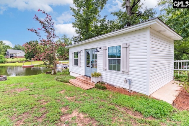 exterior space featuring a front lawn and a water view