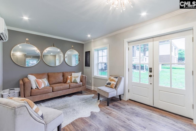 living room featuring ornamental molding, light wood-type flooring, and french doors