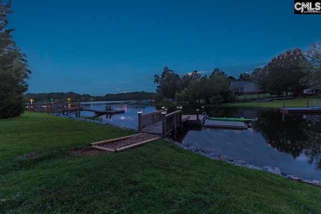 dock area featuring a water view and a lawn