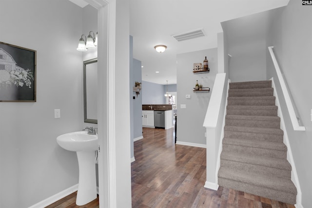 staircase with hardwood / wood-style flooring