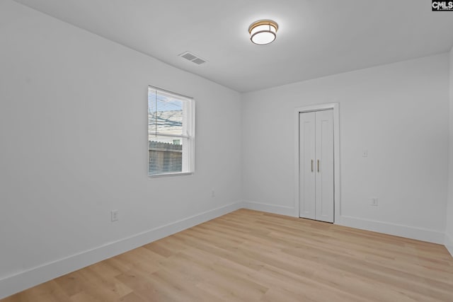 empty room with light hardwood / wood-style flooring