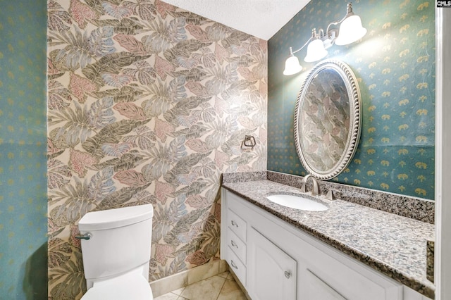 bathroom featuring vanity, tile patterned floors, a textured ceiling, and toilet