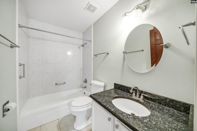 full bathroom featuring vanity, tiled shower / bath combo, tile patterned floors, and toilet