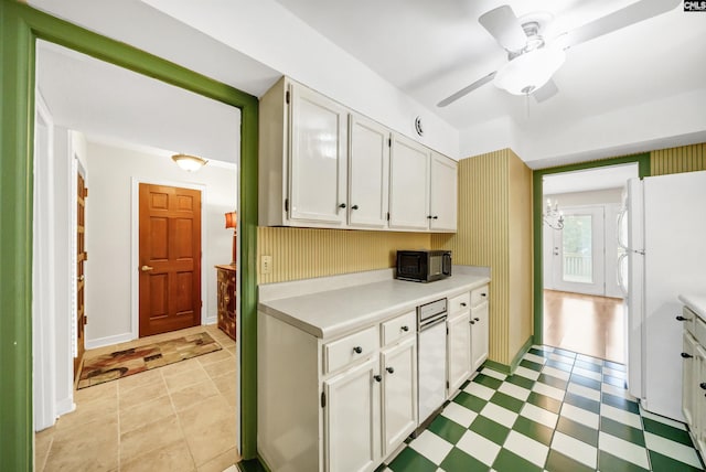 kitchen with white refrigerator, white cabinetry, and ceiling fan