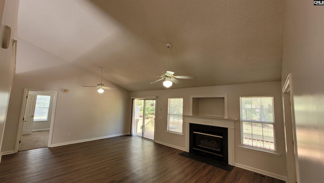 unfurnished living room featuring ceiling fan, dark hardwood / wood-style flooring, vaulted ceiling, and a textured ceiling