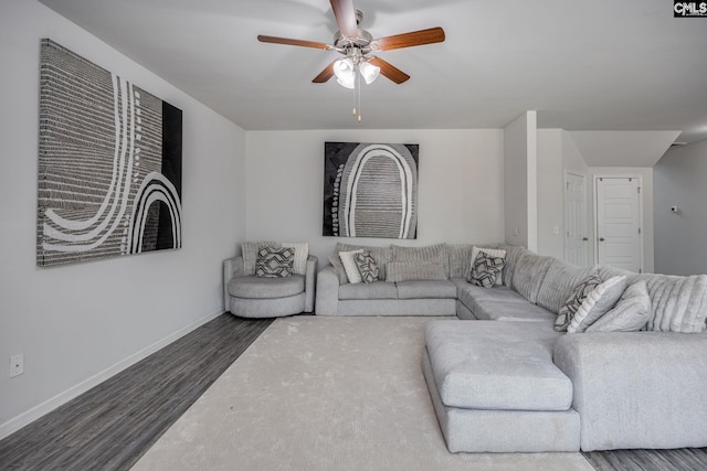 living room featuring ceiling fan and dark hardwood / wood-style floors