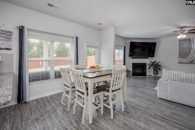 dining space featuring ceiling fan and dark hardwood / wood-style flooring