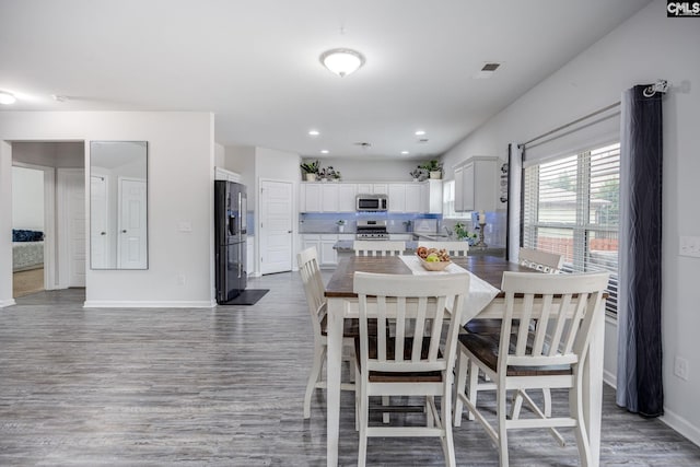 dining space featuring dark hardwood / wood-style floors