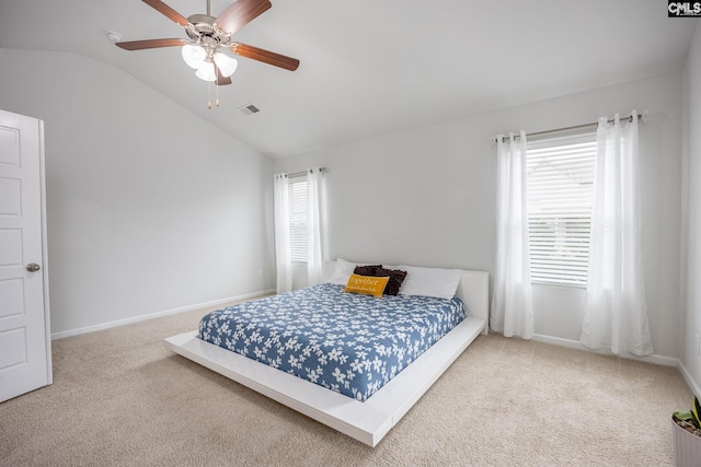 carpeted bedroom with vaulted ceiling and ceiling fan